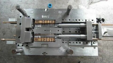 Engineers inspecting a plastic mold prototype from a China-based factory, emphasizing precision and quality.