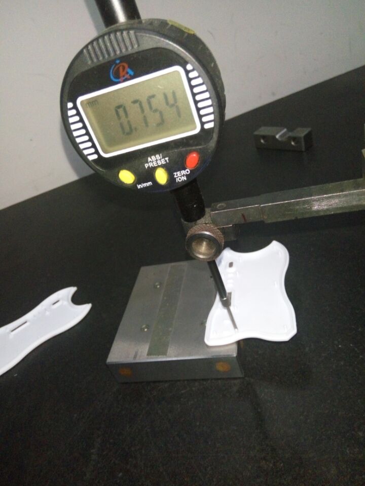 Digital contact indicator positioned on a molded housing sample